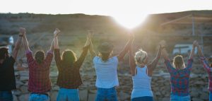 happy volunteers holding hands